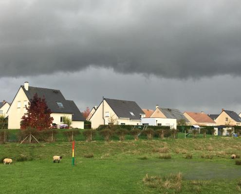 Maison sous un orage avec une échelle colorée dans un ouvrage de régulation du ruissellement